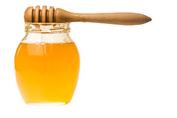 Glass jar of honey with wooden drizzler isolated on white backgr