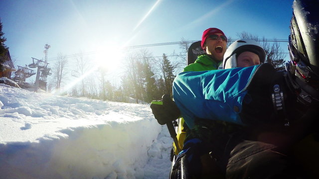 Dad and son on the Bobsleigh attraction during winter holiday.