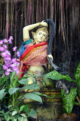 Fototapeta na wymiar Sculpture of a Buddhist deity in the Buddhist temple in Bangkokt