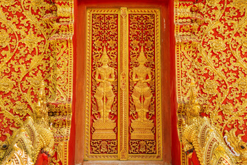 art door carving guardian giant in the temple ,Thailand