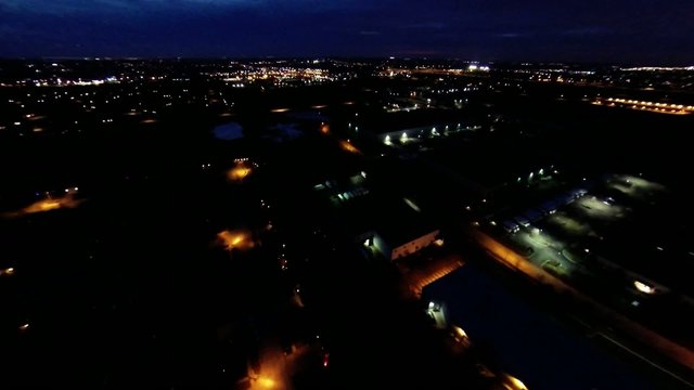 Aerial night view of house lights, streets and buildings