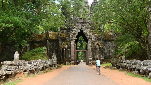 Zoom Out - Vehicles Drive through Archway on Bridge - Angkor Wat, Cambodia
