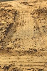 Wheel tracks on the soil.