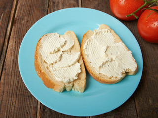 Sandwiches with cream cheese on a wooden table