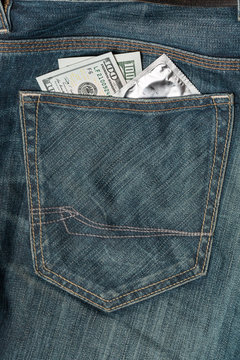 US dollars and condom in the jeans pocket