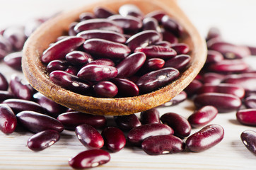 Red beans on a wooden  spoon.