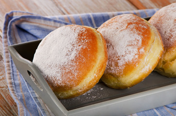 Sweet homemade donuts in wooden box.