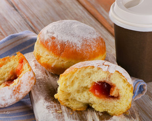 Homemade donuts and coffee cup on a wooden Table.