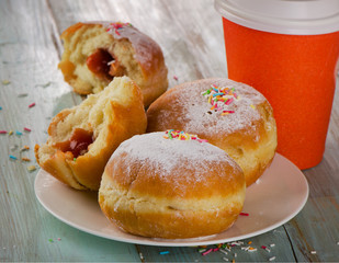 Homemade donuts and coffee on a wooden Table.