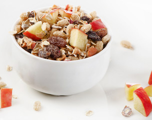 Healthy muesli and apple for breakfast in a bowl