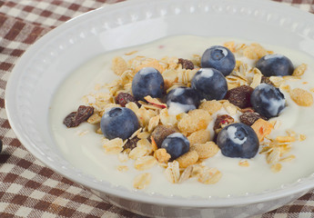 Healthy breakfast - yogurt with blueberries and muesli served in
