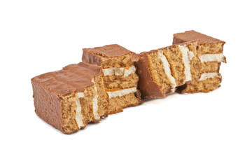 The broken pieces of chocolate biscuit isolated on white