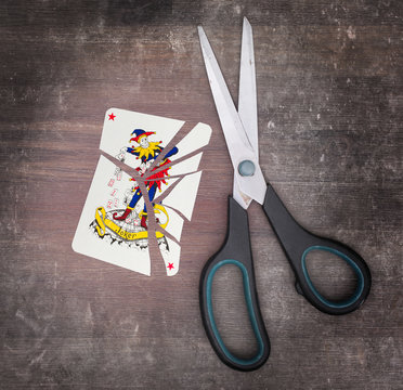 Concept of addiction, card with scissors