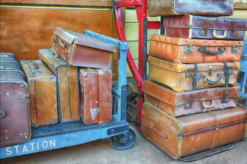 Old suitcases on trolleys in a station