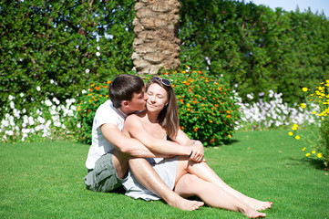 young couple sitting on the grass