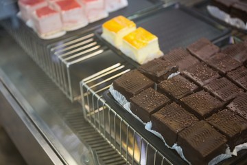 Close up of brownies and slices of cheesecake