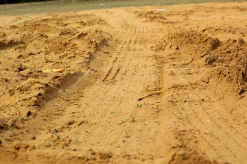 Wheel tracks on the soil.