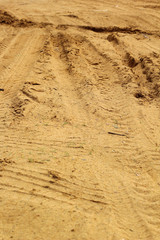 Wheel tracks on the soil.