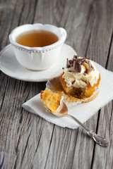 Vanilla cupcake on wooden table