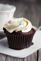 Chocolate cupcake on wooden table