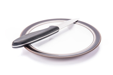 Fototapeta premium knife and plate on white background