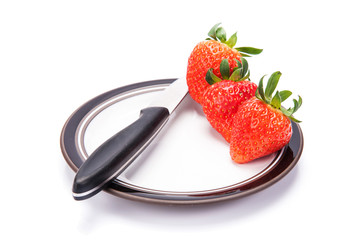 fresh garden strawberries on a white plate