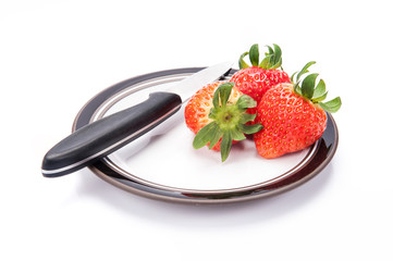 fresh garden strawberries on a white plate