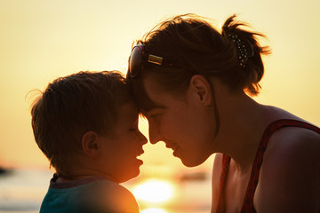 mother and son at sunset beach
