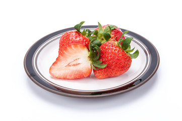 fresh garden strawberries on a white plate