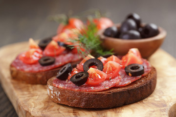 open rye sandwich with salami and vegetables