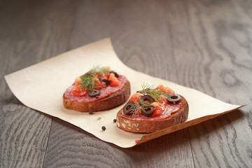 open rye sandwich with salami and vegetables