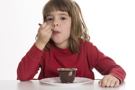 Little Girl Eating A Custard