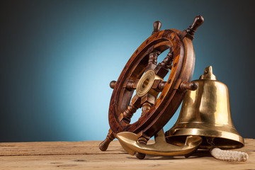maritime adventure  anchor bell and old wooden steering wheel - obrazy, fototapety, plakaty
