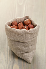 sack bag full of hazelnut kernels, rustic style photo
