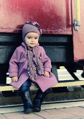 Little cute girl ready to vacation on railway station, baby girl