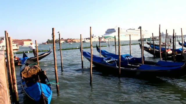 Gondolas at rest by Piazza San Marco and cruise ship