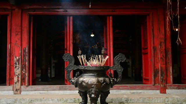 Incense Sticks Burning in Giant Pot in Front of Buddhist Temple 
