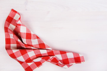 red checkered napkin on wooden background