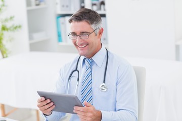 Male doctor using tablet computer