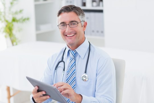 Portrait of doctor using tablet computer