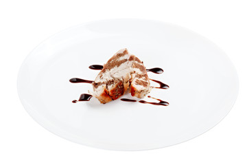 Chicken with balsamic sauce on a white plate isolated.