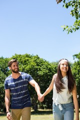 Hipster couple walking in the park