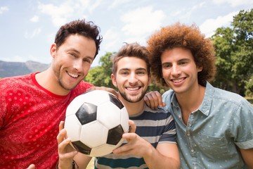 Happy friends in the park with football