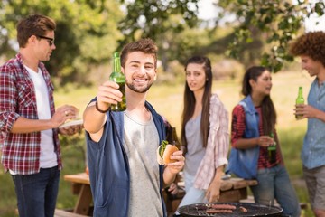 Happy friends in the park having barbecue