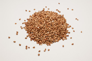 Buckwheat grains pile isolated on white background