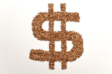 dollar sign made of buckwheat on  white background