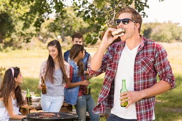 Fototapeta na wymiar Happy friends in the park having barbecue