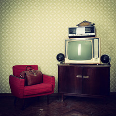 Vintage room with wallpaper, old fashioned armchair, retro tv, b
