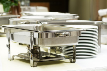 metal kitchen equipments and plates on the table