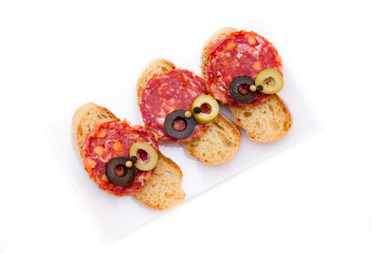 Bruschetta with salami and olives from above